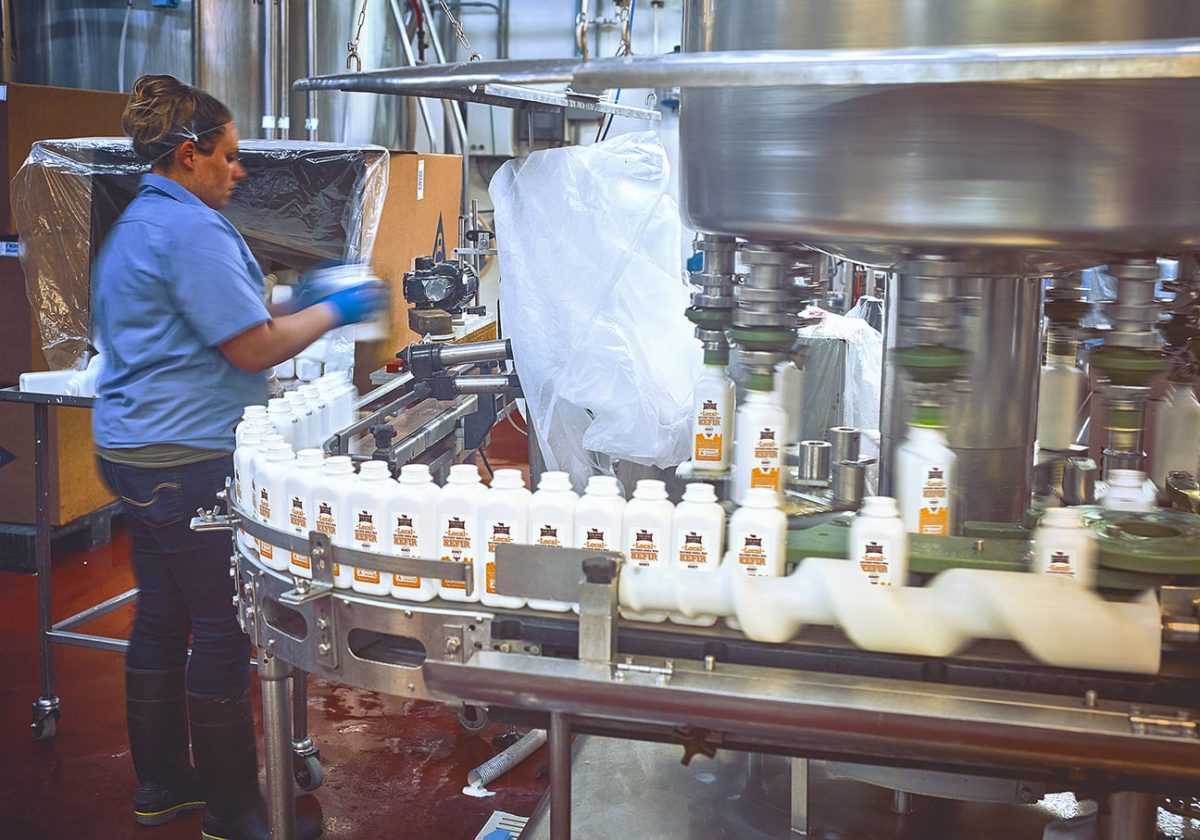 Containers, waiting to be filled with our Local Honey Kefir, are placed on the line.